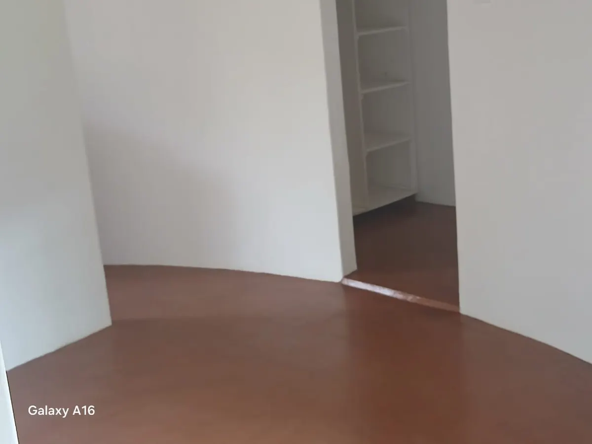 Rondavel interior with built-in shelving