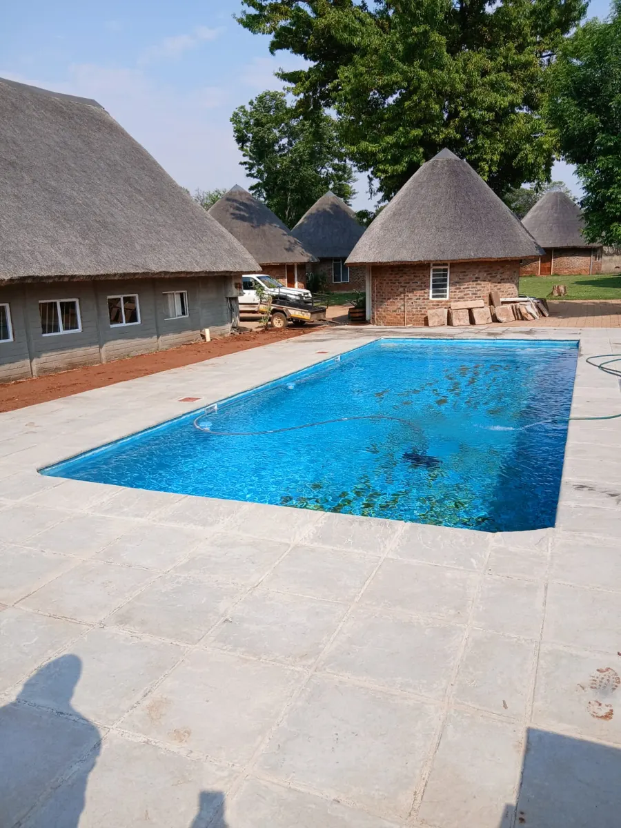 Thatch lodge with new pool and paving built by Delta Construction